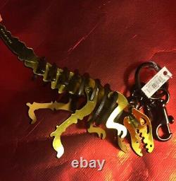 NEW NWT Coach Rexy T-rex Bag Charm Keychain Dinosaur Metallic Yellow Gold Puzzle